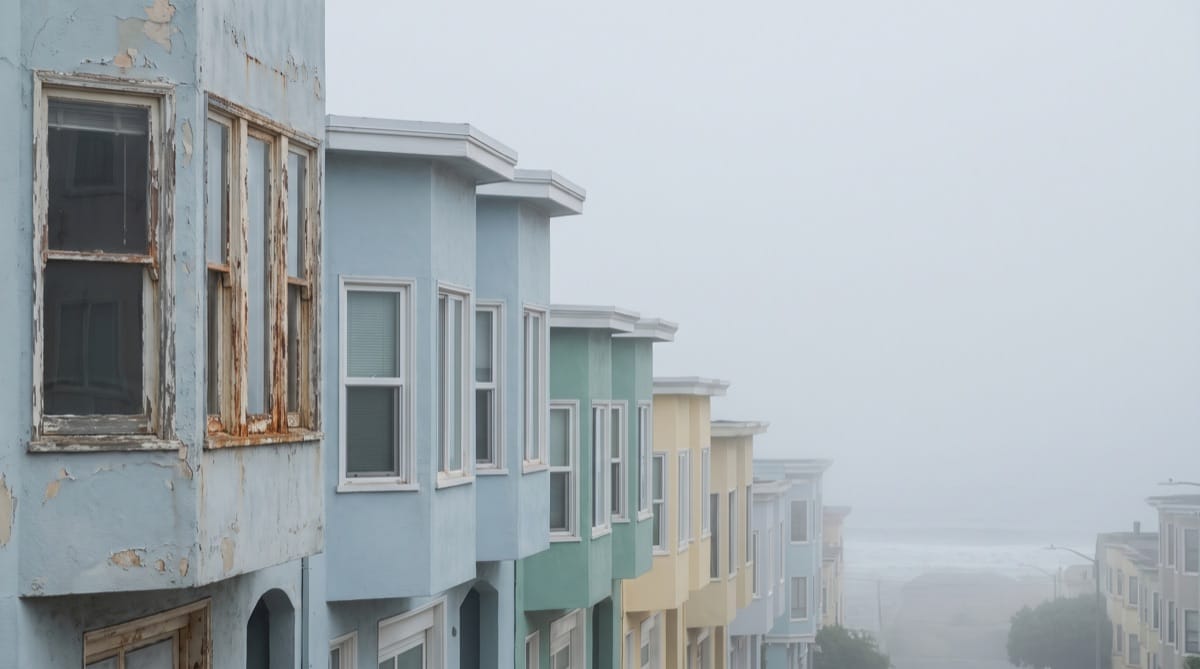 Foggy street of pastel homes in San Francisco's Outer Sunset district
