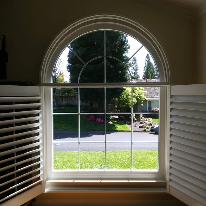 Arched picture window with interior shutters