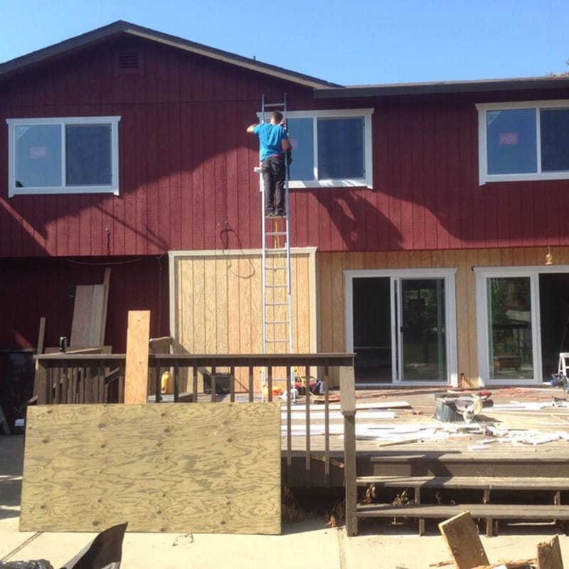 Installer replacing vinyl windows on Bay Area home