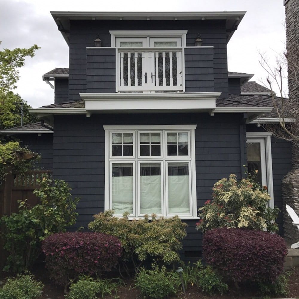 Dark shingle-clad Craftsman home with new picture window and French balcony doors