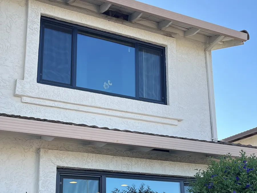 Stucco home with new black-frame windows and slider, Millbrae, CA
