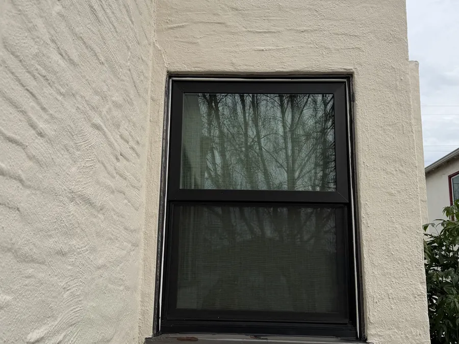 Dark bronze double-hung window on a textured stucco wall, Menlo Park, CA