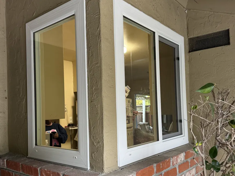 Two new corner windows above a red brick planter, San Mateo, CA