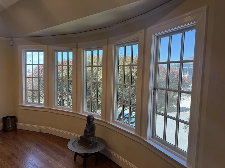 Interior of a curved bay with five new grid-pattern windows, Burlingame, CA