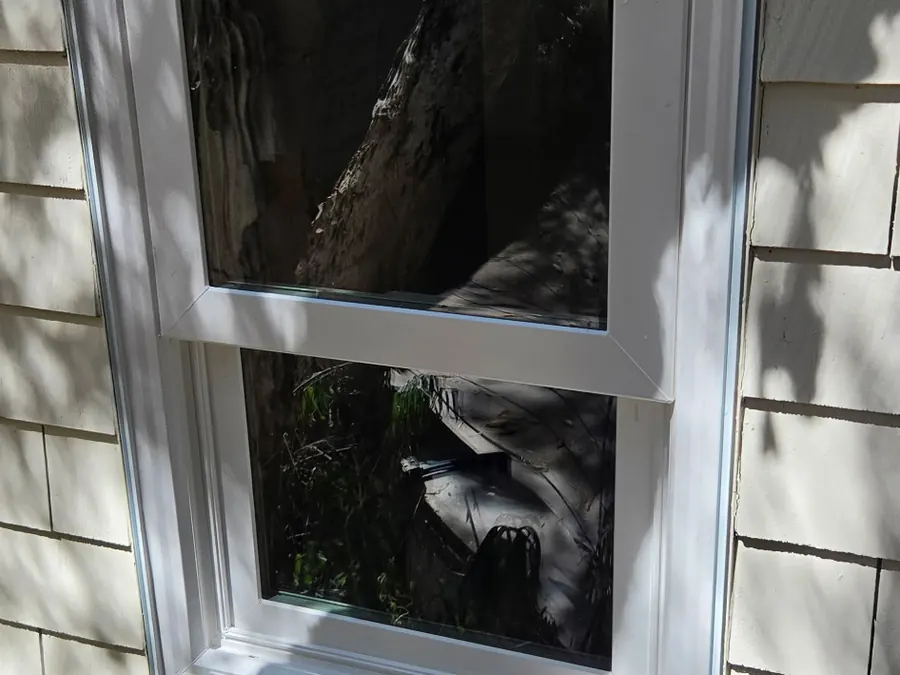 New white double-hung window set into cedar shingle siding, Menlo Park, CA