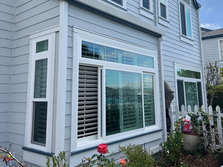 Bay window and transom slider on a gray lap-siding townhome, Foster City, CA