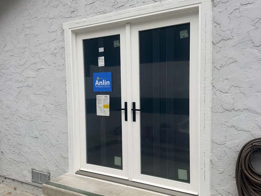 Pair of new white French doors on a textured stucco home, San Bruno, CA