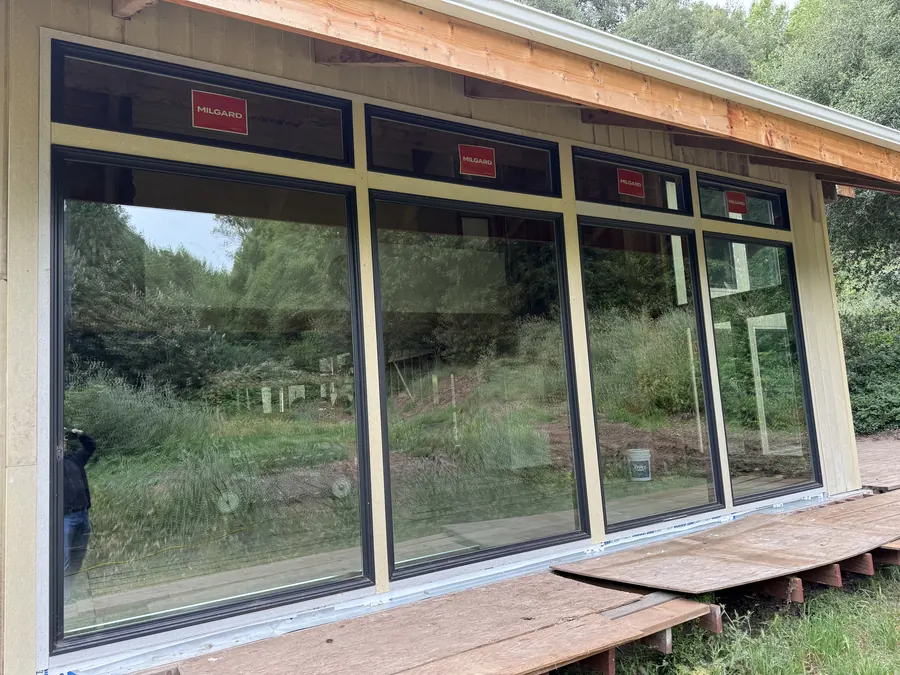 Floor-to-ceiling glass panels opening to a new deck, Redwood City, CA