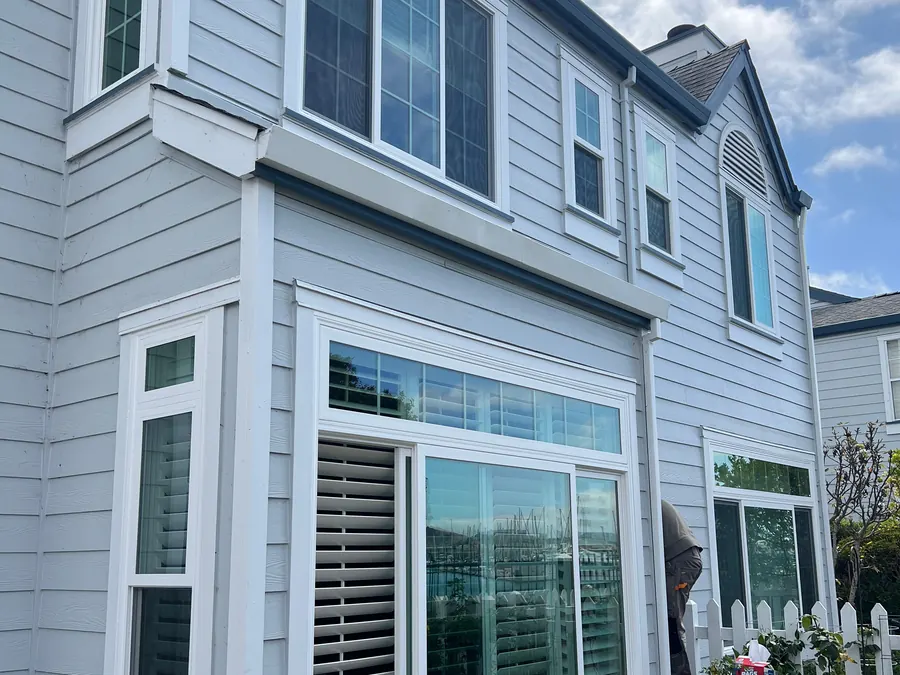 Gray colonial-style home with new windows and white trim, Redwood City, CA