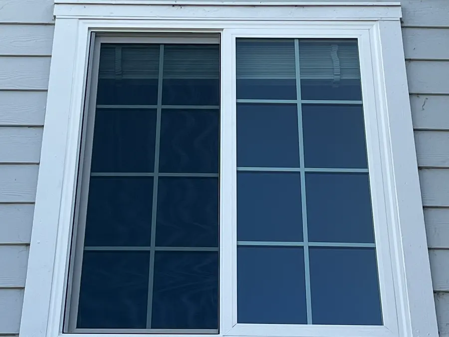 White sliding window with colonial grids on gray siding, Foster City, CA