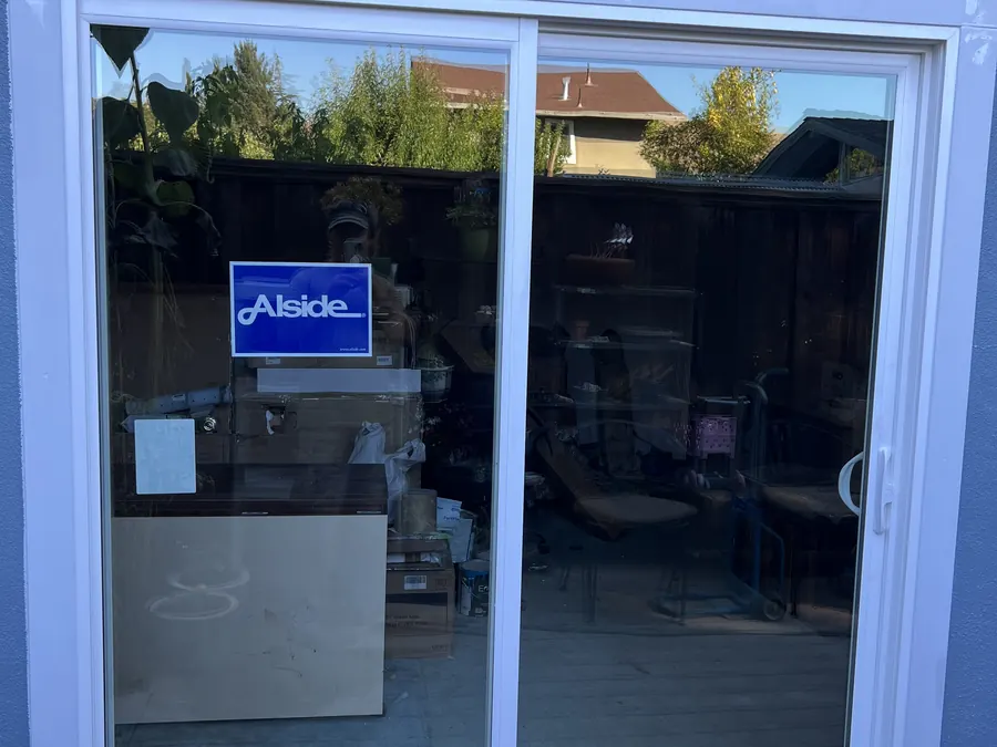 New white sliding patio door on a gray stucco wall, Daly City, CA