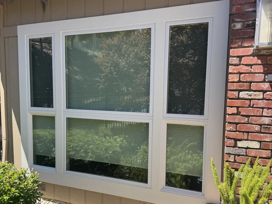 Row of new white windows along a garden and brick path, Palo Alto, CA